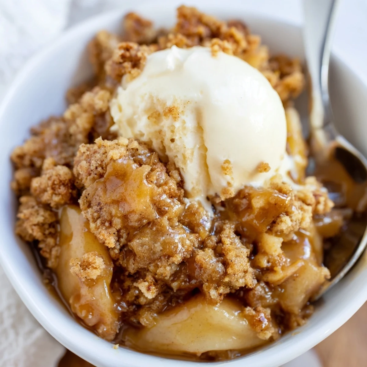 Warm Gingerbread Caramel Apple Cobbler with spiced topping and juicy apple filling.  
