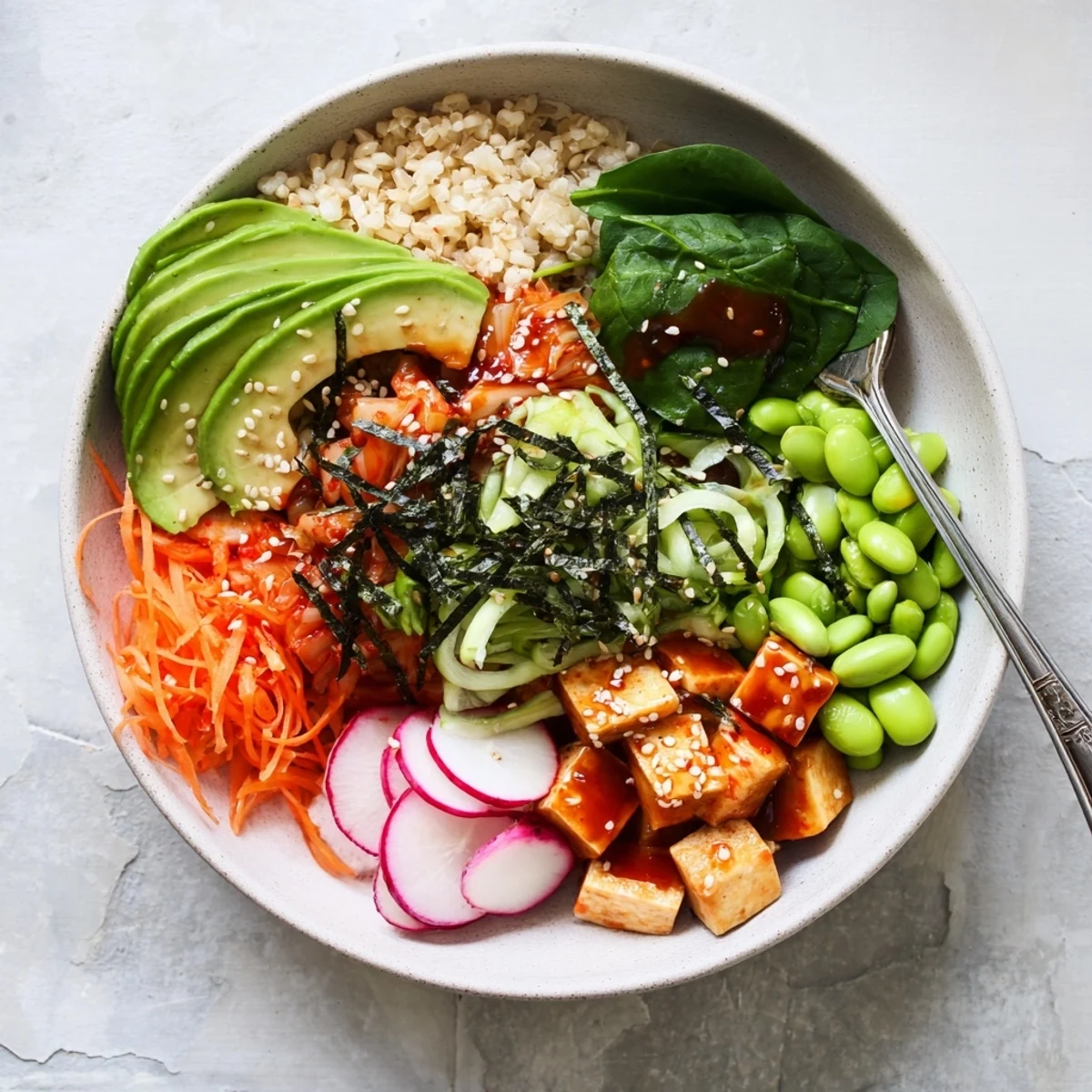 A colorful fermented vegetable bowl topped with kimchi and fresh greens.  