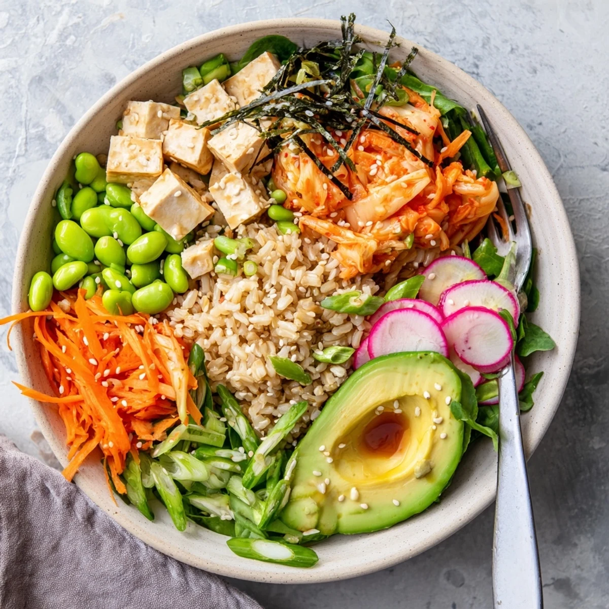 Savory fermented vegetable bowl featuring vibrant kimchi and creamy avocado slices.  