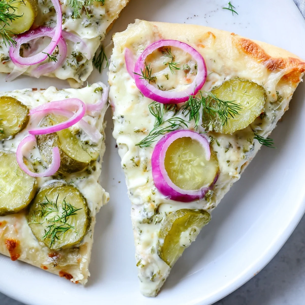 Mouthwatering Pickle Pizza fresh from the oven, drizzled with crème fraîche sauce.