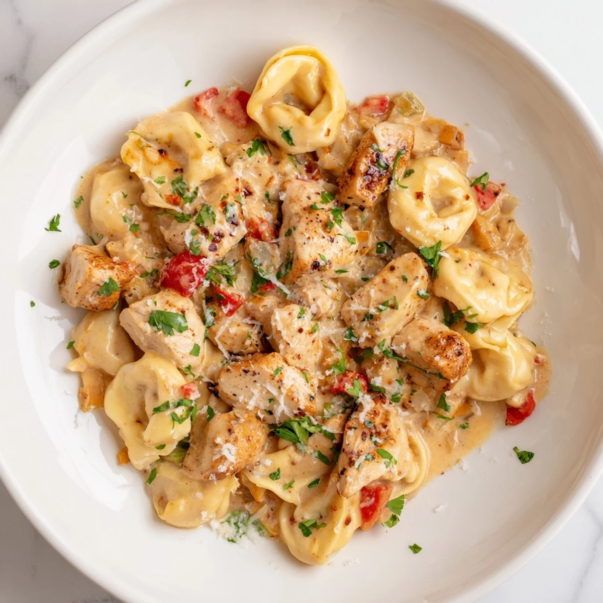 Creamy Cajun Garlic Parmesan Chicken Tortellini, a vibrant pasta dish ready for the dinner table.