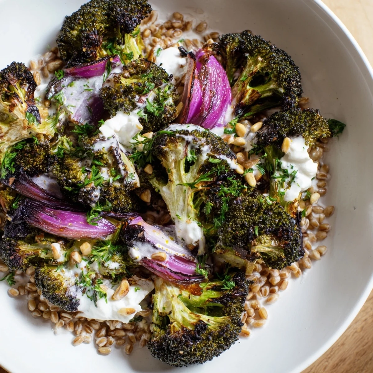 Warm roasted broccoli with a garlic-lemon dressing served over fluffy farro; it's a vibrant, healthy meal.