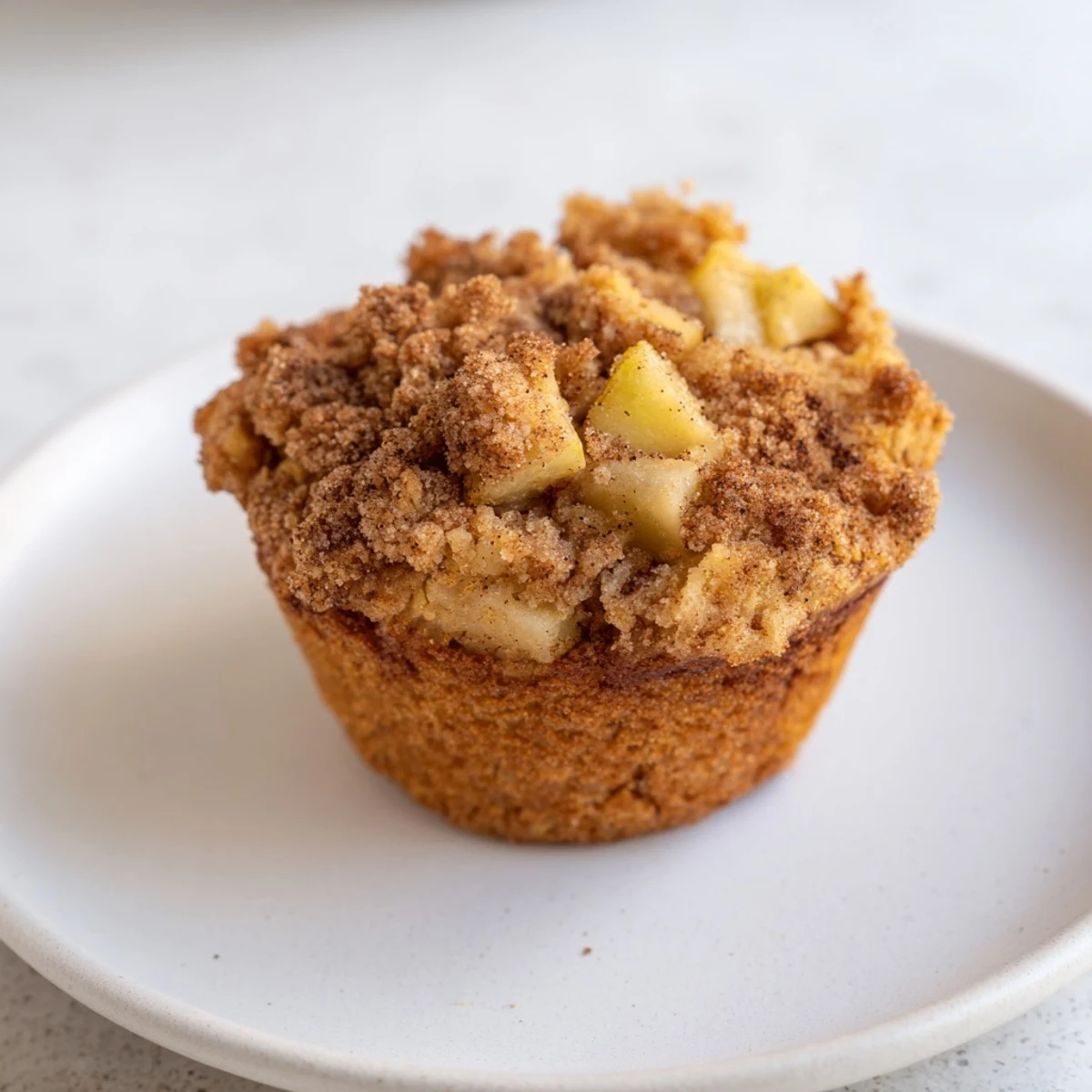 Warm, golden Cinnamon Apple Muffins fresh from the oven, offering a delightful aroma and flavor.