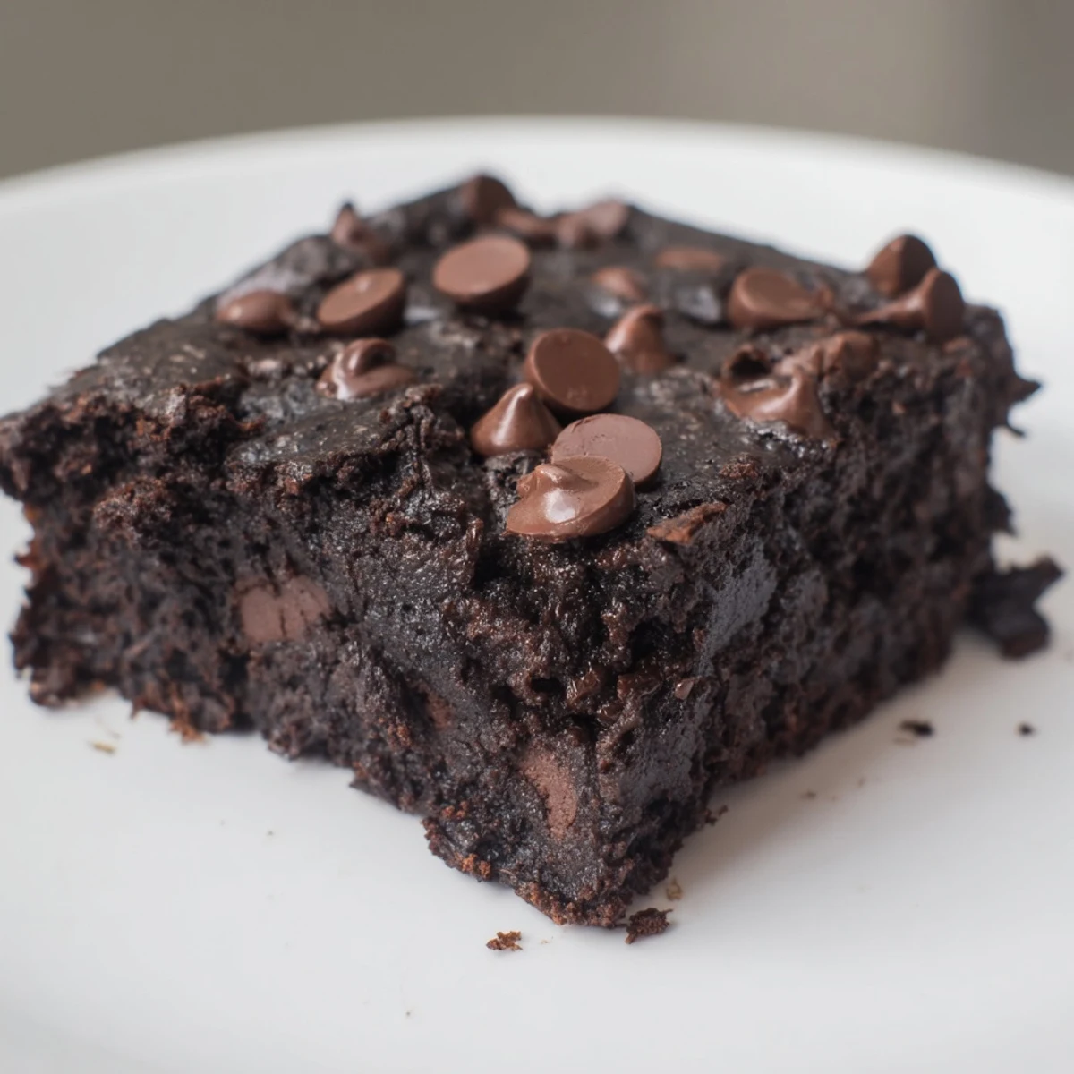 Close-up of baked Black Bean Brownies, dark and dense, perfect with a scoop of vanilla ice cream.