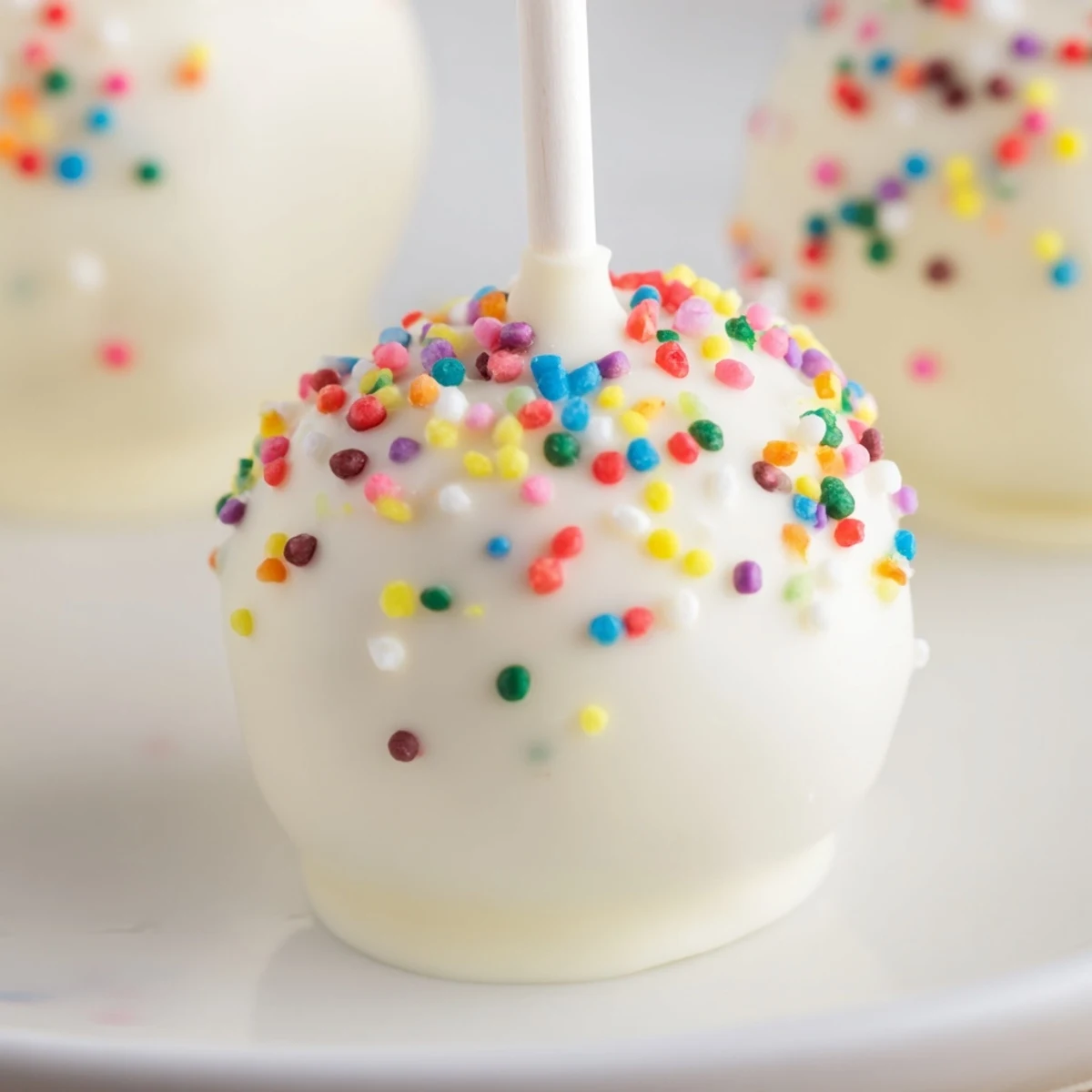 Freshly made Lightened-Up Sugar Cookie Cake Pops, a creamy, sweet American dessert everyone will enjoy.