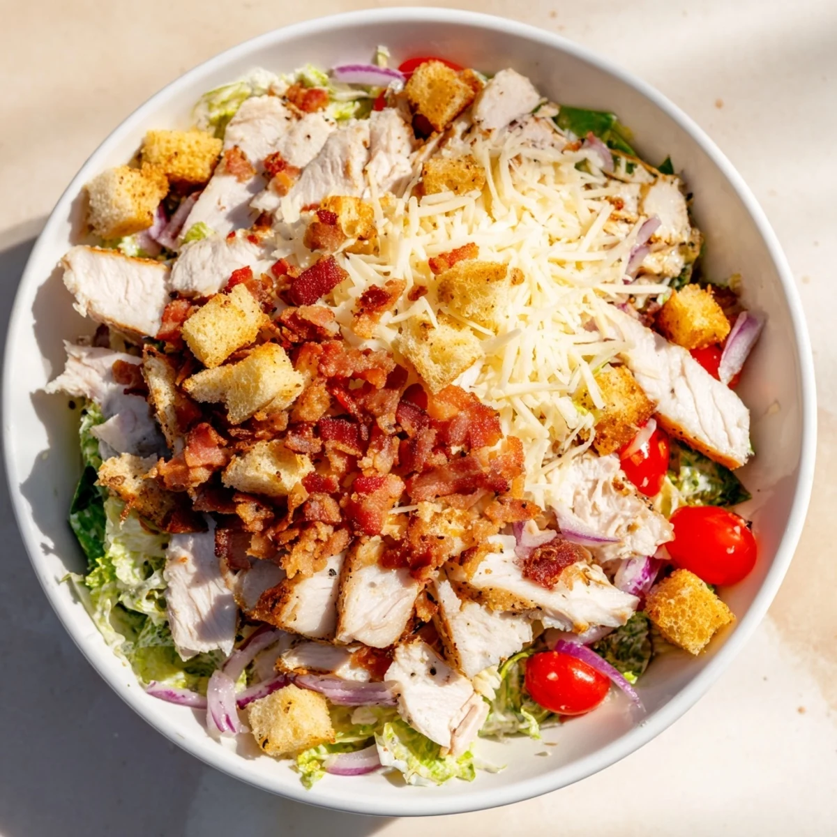 Costco Chicken Bake Salad Bowl brimming with juicy chicken, crispy bacon, and creamy dressing.