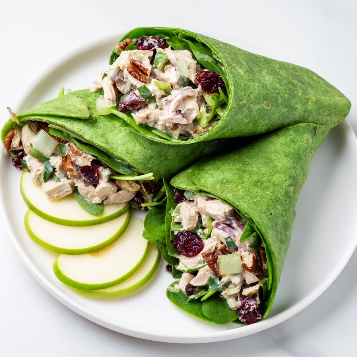 Cranberry Pecan Chicken Salad Christmas Wrap, overflowing with juicy chicken and bright red cranberries.