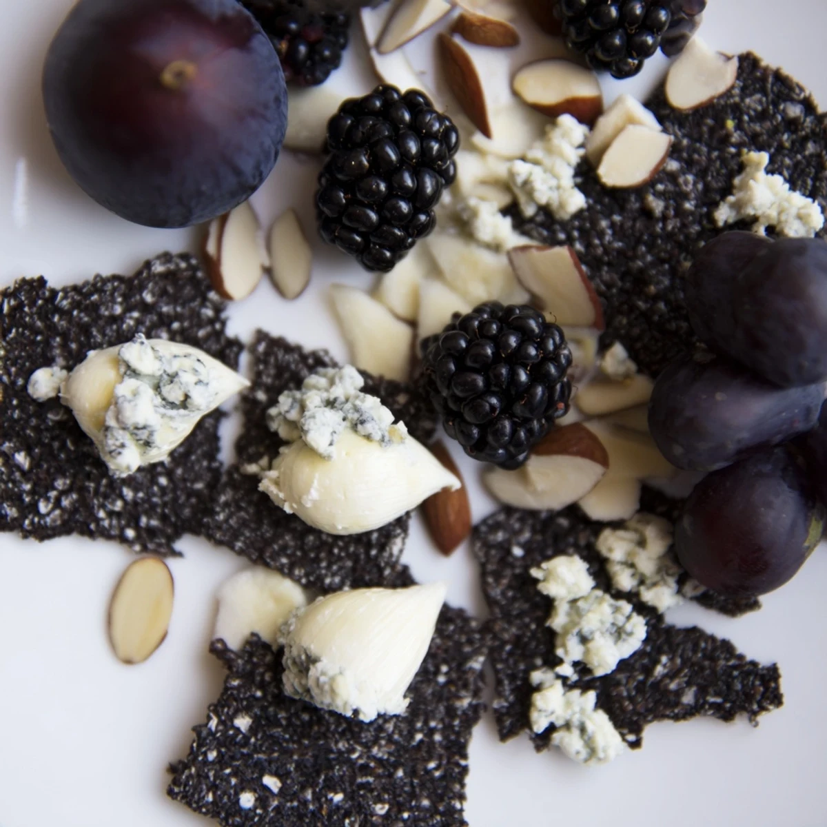 Artfully arranged Deep Indigo Midnight Sky cheese board, offering a delicious vegetarian appetizer with gluten-free options.