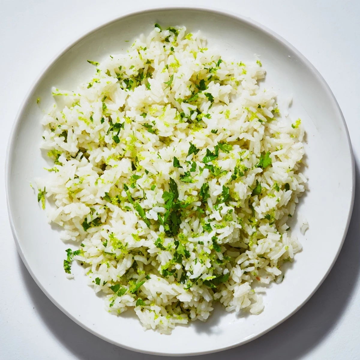 A serving of warm Cilantro Lime Rice, offering a zesty freshness from lime juice, perfect side for dinner.