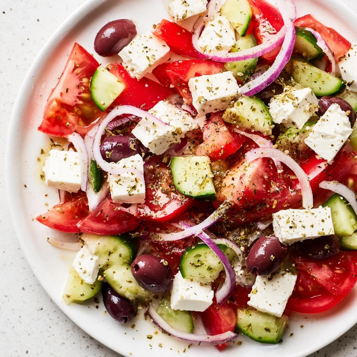 A colorful Mediterranean salad with tomatoes, cucumbers, and creamy feta, ready to enjoy.