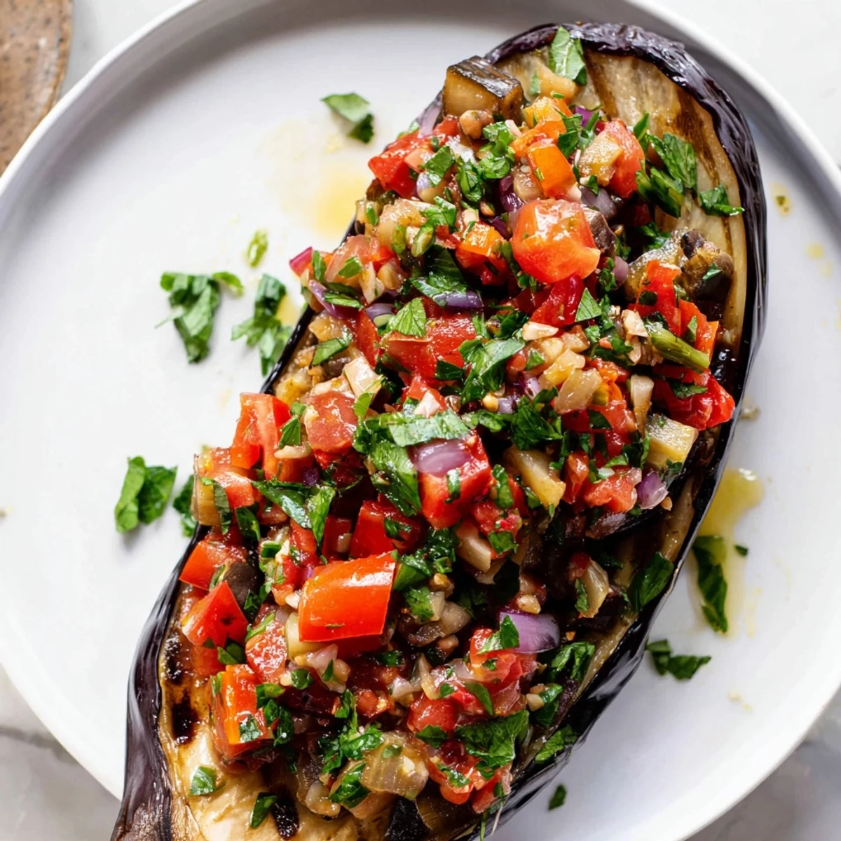 Perfectly baked Imam Bayildi, showcasing soft eggplant halves filled with savory tomato sauce and herbs.