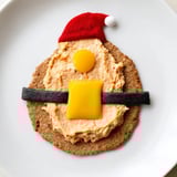 Festive Santa's Belt Crackers featuring melted cheddar and a vibrant roasted red pepper dip, visually appealing.