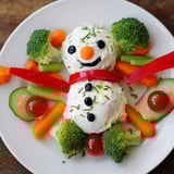 Festive Snowman Veggie Dip Platter featuring a creamy, homemade dip shaped like a snowman with colorful, crunchy veggies.