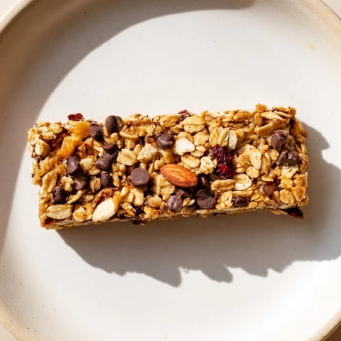 Golden-brown homemade granola bars, ready to eat with oats, nuts, and chocolate chips.