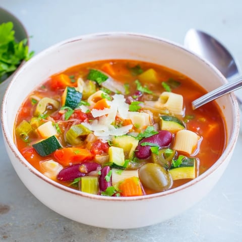 Steaming bowl of Veggie-Packed Minestrone Christmas Pasta Pot, ready to warm you up on a chilly evening.