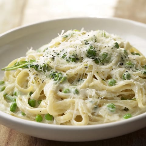 Creamy Greek Yogurt Spinach Alfredo Pasta with vibrant green spinach and grated Parmesan cheese.