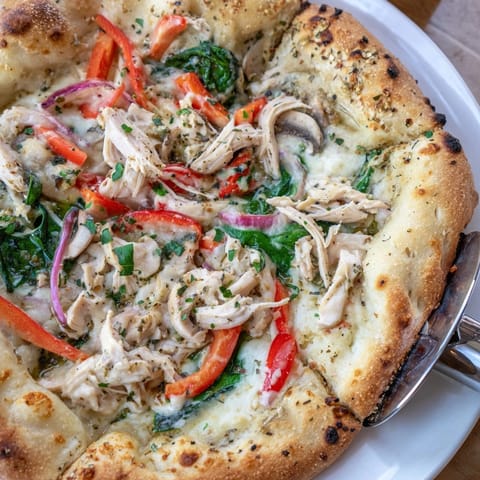 Golden-crusted Alfredo Chicken Veggie Pizza, a comforting, cheesy delight fresh from the oven.