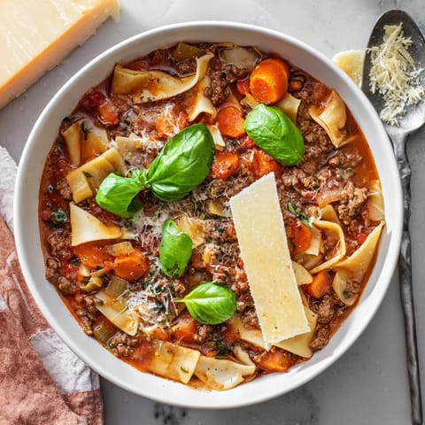 A comforting bowl of Lasagne Soup featuring melted cheese and savory flavors.  