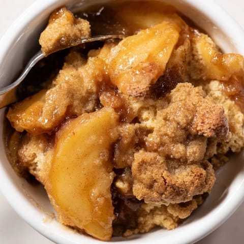 Deliciously layered Gingerbread Caramel Apple Cobbler, perfect served warm with ice cream.  
