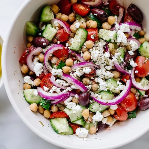 Refreshing Greek salad with chickpeas and fresh vegetables, perfect for a light lunch.  