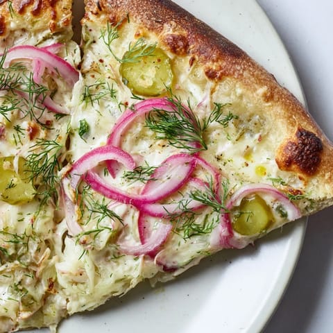 Deliciously unique Pickle Pizza with mozzarella and zesty dill, perfect for sharing.  