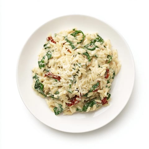This creamy Tuscan orzo bowl offers a rich, comforting meal with a sprinkle of Parmesan.