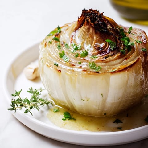 Golden-brown Onion Boil with softened layers, featuring fragrant roasted thyme and meltingly sweet onion.