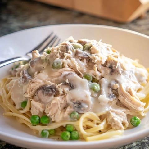 Slow-cooked Creamy Chicken Alfredo with tender, shredded chicken in a rich, creamy sauce, ready to serve.