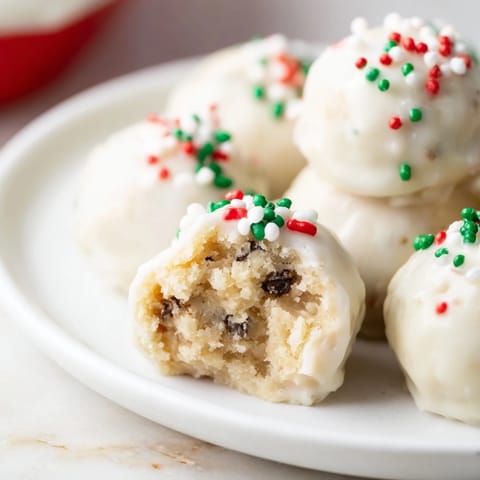 Golden Italian Christmas Cookie Balls glistening with a sweet glaze and festive sprinkles, ready to be devoured.