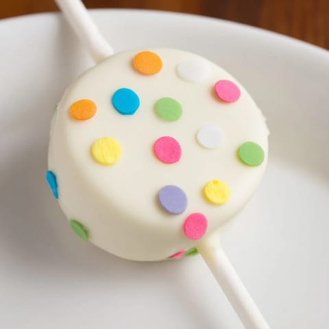 Bite into these Lightened-Up Sugar Cookie Cake Pops, dipped in white chocolate, a delightful dessert.