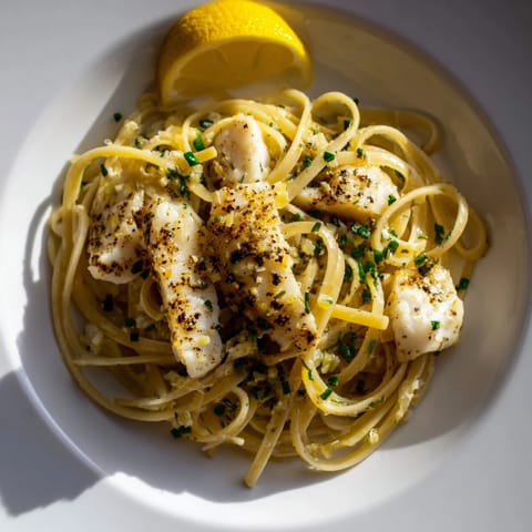 Delicious, pan-fried fish paired with pasta in this bright Crispy Fish Pasta recipe, bursting with flavor.