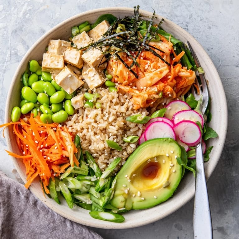 Savory fermented vegetable bowl featuring vibrant kimchi and creamy avocado slices.  