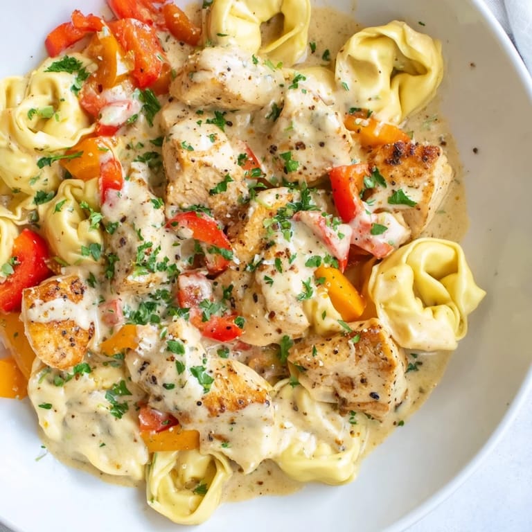 Savor the flavors of Zesty Cajun Garlic Parmesan Chicken Tortellini, a perfect weeknight meal with cheesy pasta.