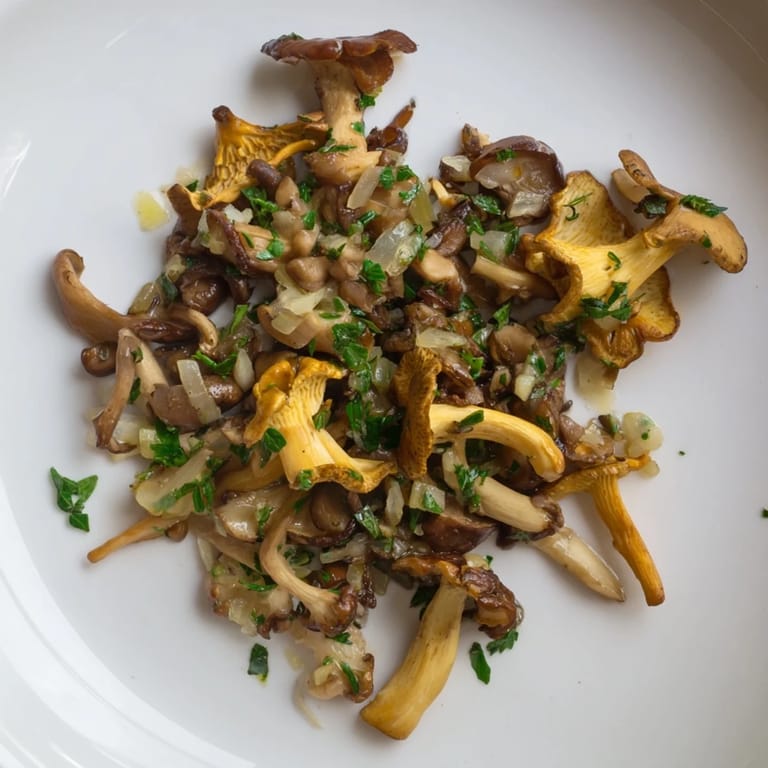 Imagine flavorful Enchanted Forest Mushrooms with a rich white wine sauce, garnished with fresh chives, a perfect side dish.