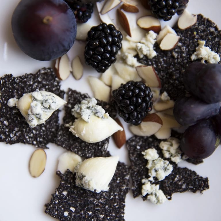 Artfully arranged Deep Indigo Midnight Sky cheese board, offering a delicious vegetarian appetizer with gluten-free options.