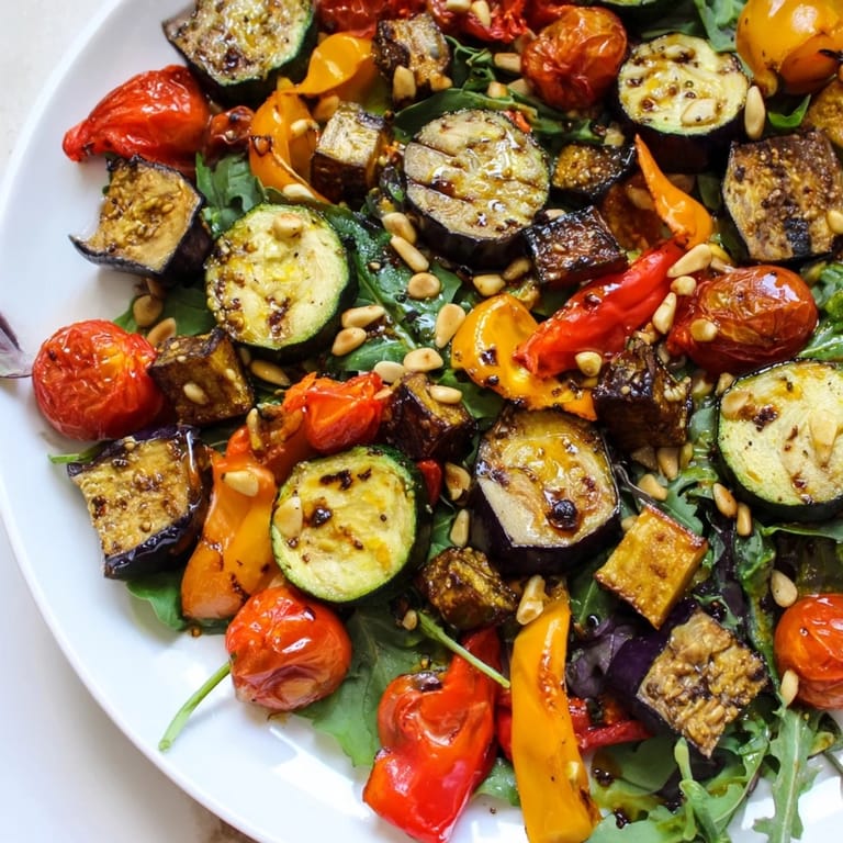 Fresh greens topped with roasted vegetables, creating a vibrant Roasted Vegetable Salad.