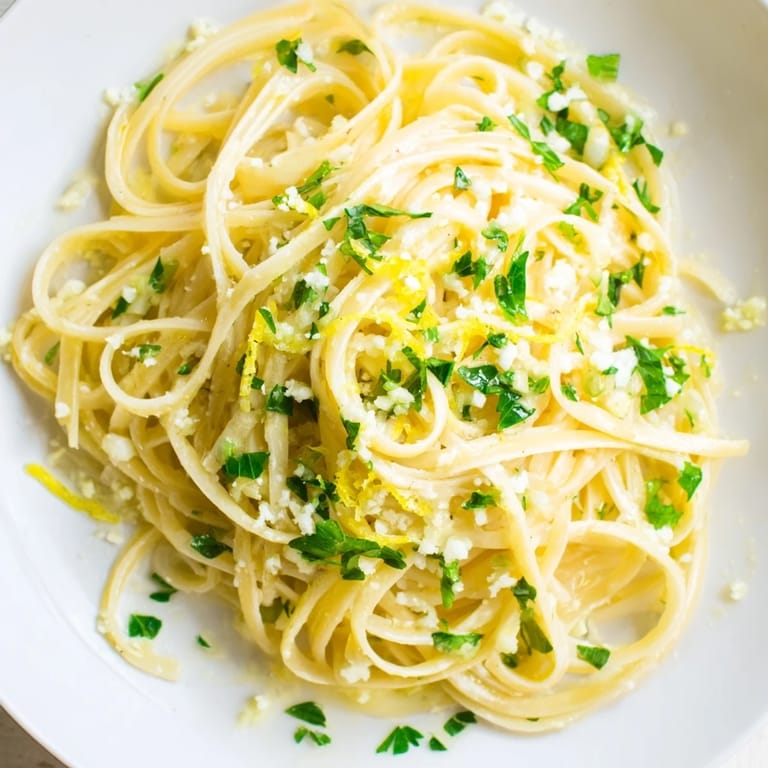 Steaming bowl of Garlic Butter Linguine, tossed with fresh herbs, ready for a comforting meal.