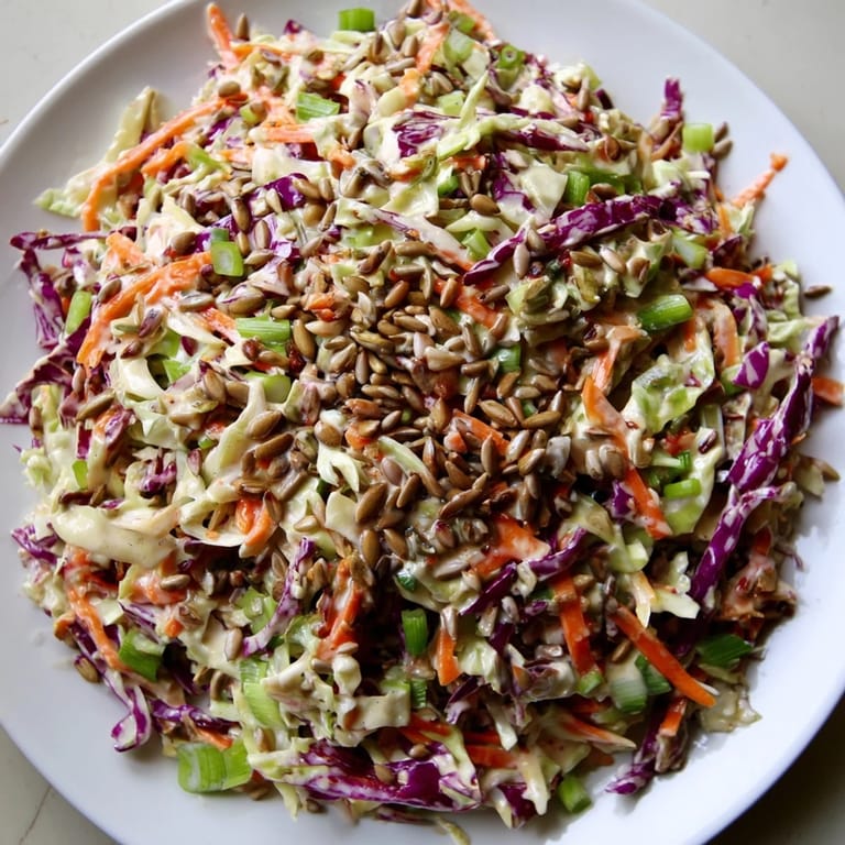 Freshly tossed Crunchy Coleslaw Salad with bright vegetables and sunflower seeds offering a delightful crunch and flavor.