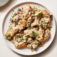 Tender Creamy Chicken Stroganoff over egg noodles, visually appealing with a rich mushroom sauce.